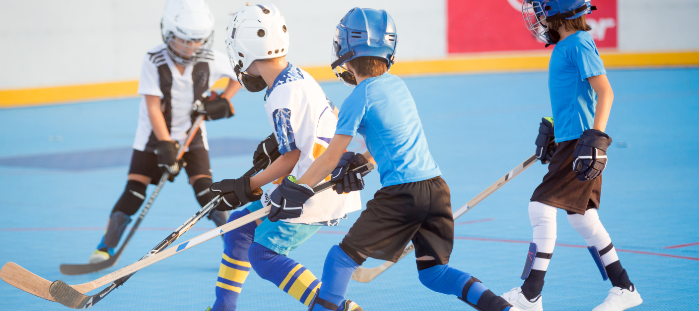 1042936086 Team players having competitive hockey game