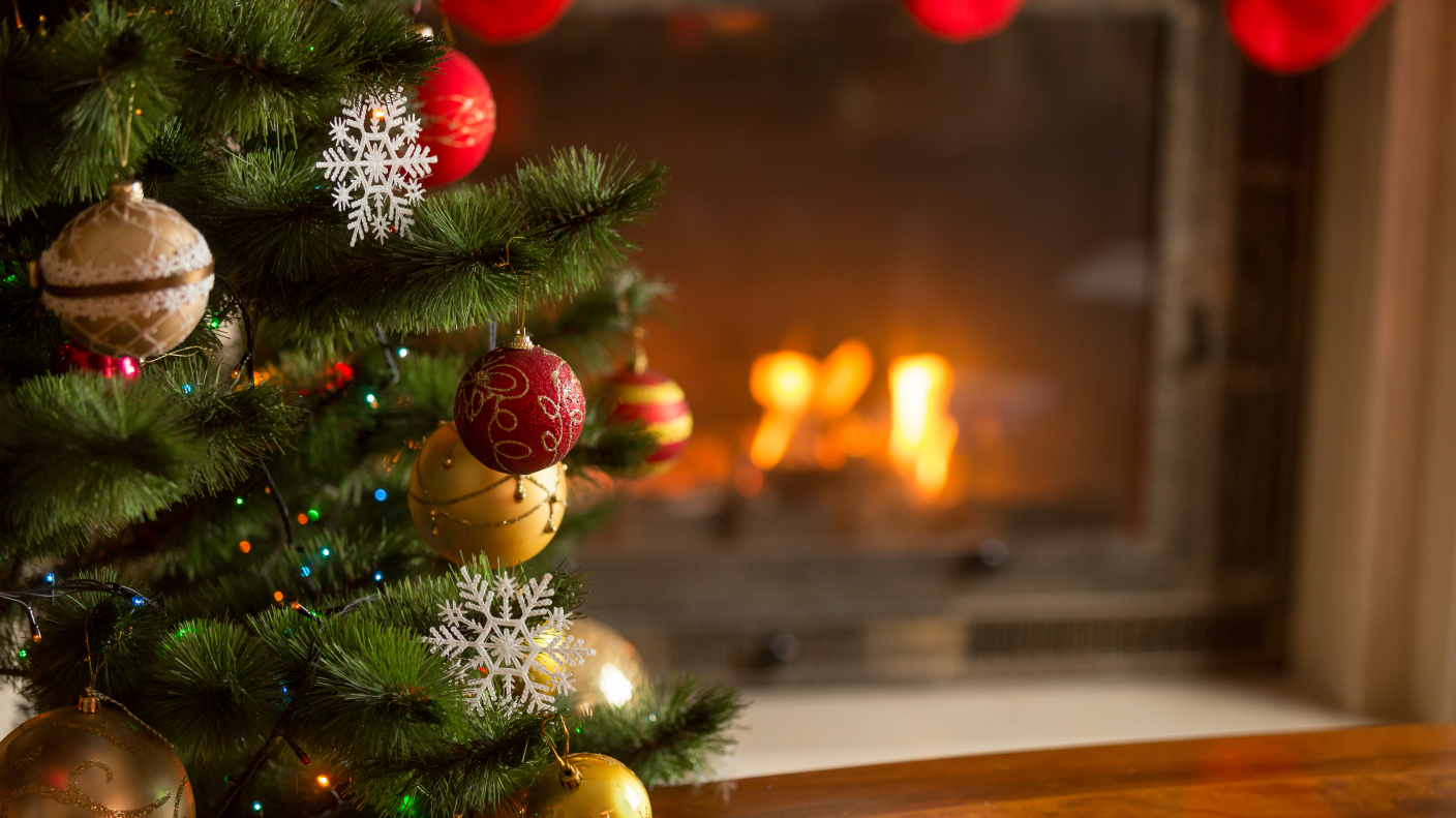 610759024 Closeup image of golden baubles on Christmas tree at fireplace