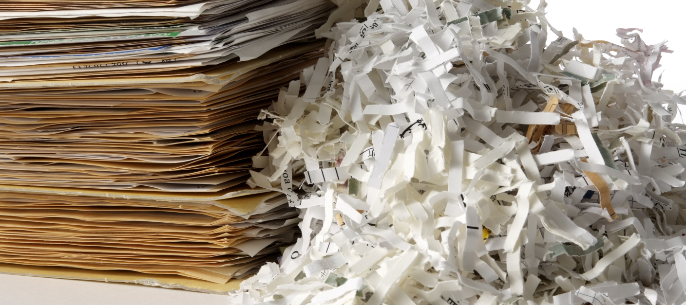 Isolated shot of shredded documents with folder on white background Isolated shot of shredded documents with folder on white background