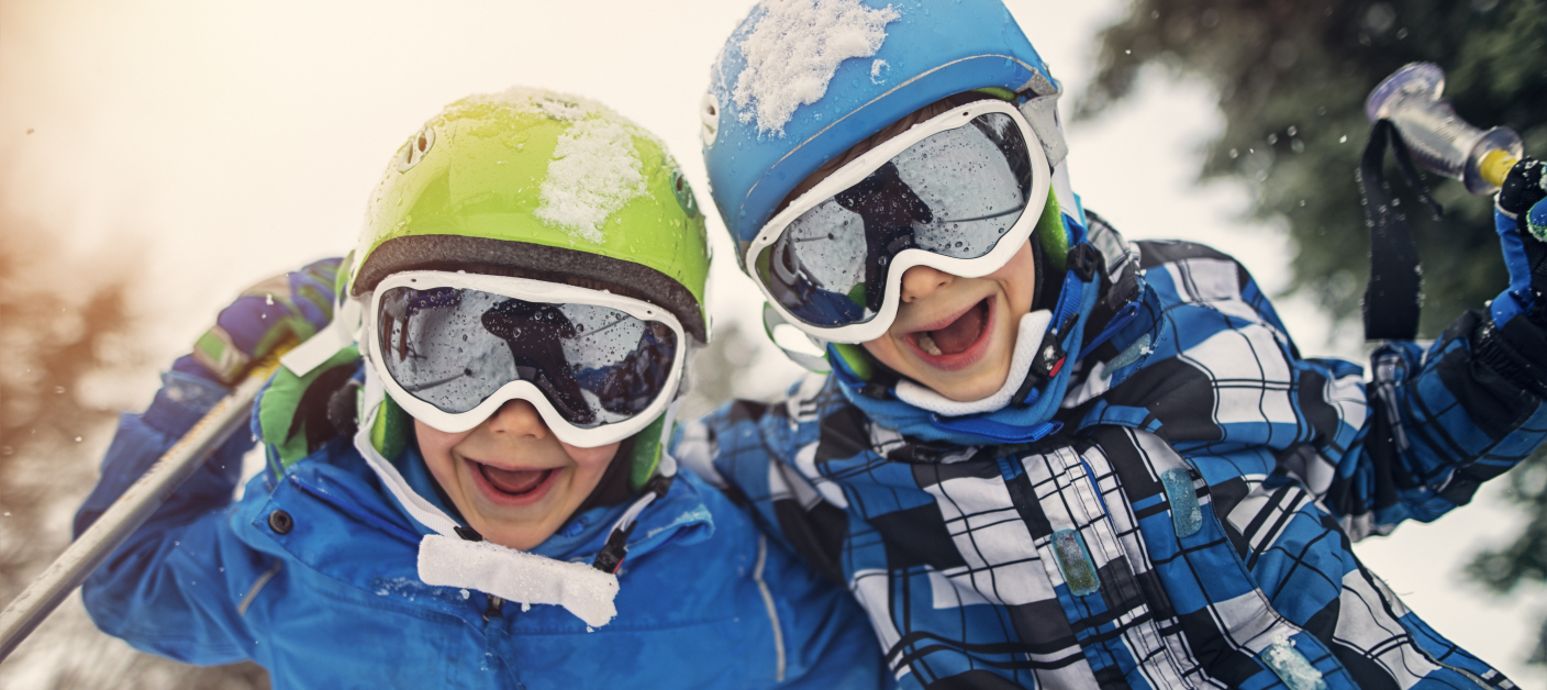 Portrait of little skiers laughing at the camera Portrait of little skiers laughing at the camera