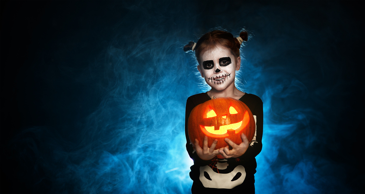 magic skeleton with pumpkin. baby girl in costume to halloween magic skeleton with pumpkin. baby girl in costume to halloween