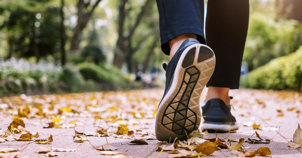 1169098665 Woman walking in park outdoor Exercise healthy lifestyle