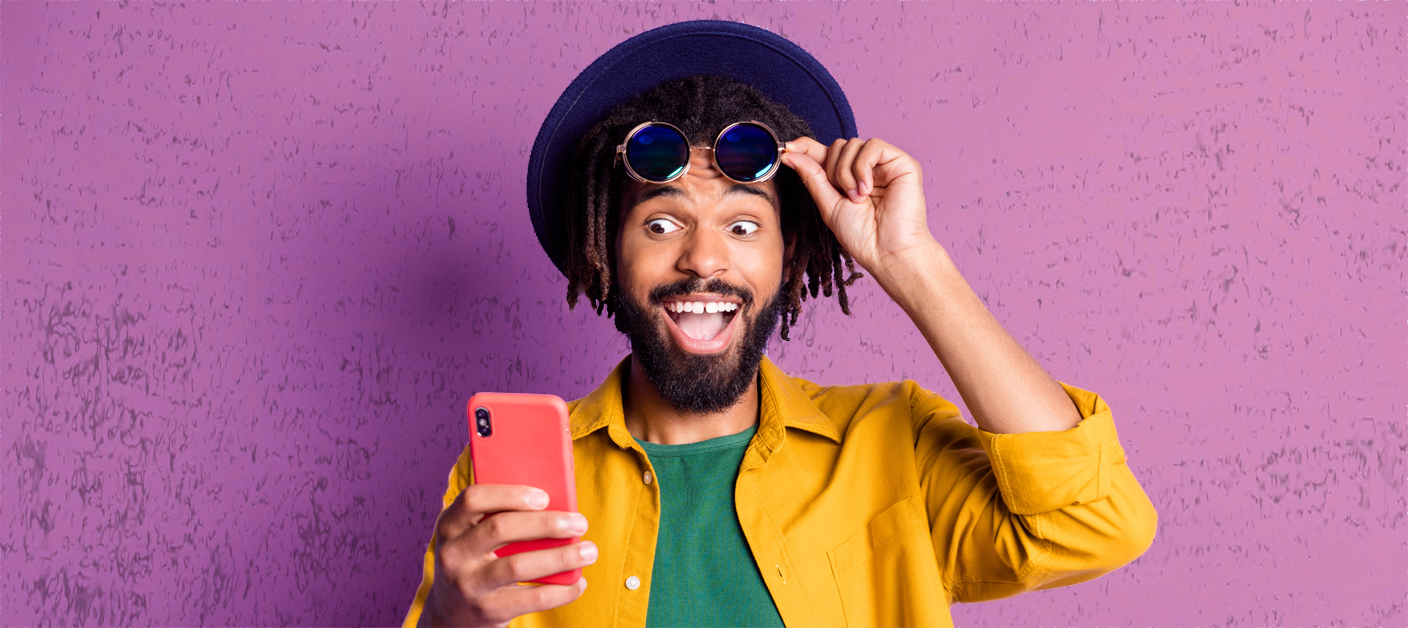 1324035265 Photo of impressed funny dark skin guy hand touch sunglass look phone like subscribe isolated on violet color background