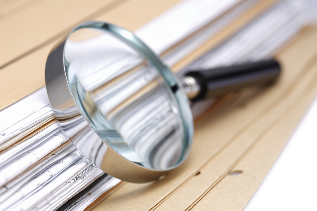 Magnifying glass Search Documents ; shot with very shallow depth of field ,
